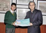 Honorary Consul Czech Republic in Lahore Mr. Kamal Monnoo gives diploma to awardeded boy Shaheer Hassan Khan
